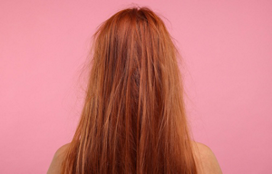 Redheaded woman with damaged, frizzy hair